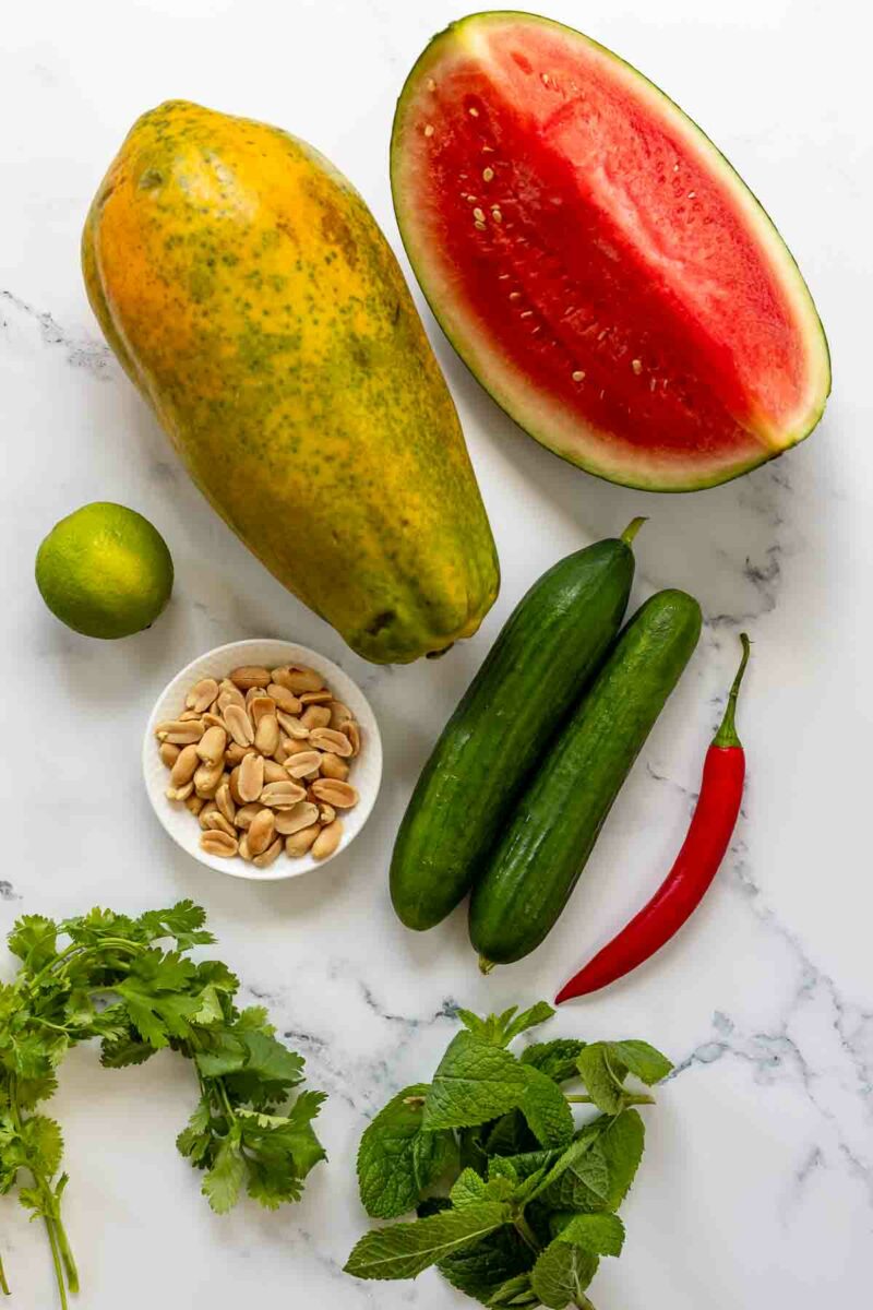 Ingredients: Chili Fruit Salad with Papaya, Watermelon, Cucumber, roasted peanuts, cilantro and mint