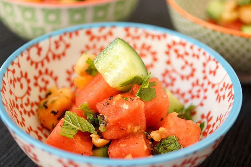 Bowl of Chili Fruit Salad with Papaya, Watermelon, Cucumber, roasted peanuts, and fresh herbs recipe