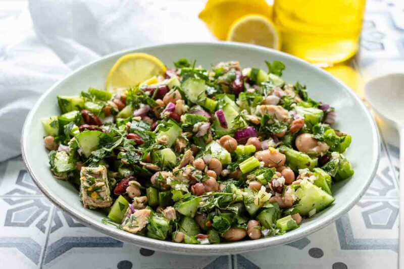 Mediterranean bean salad with tuna, lemon, garlic, herbs, cucumber and celery.