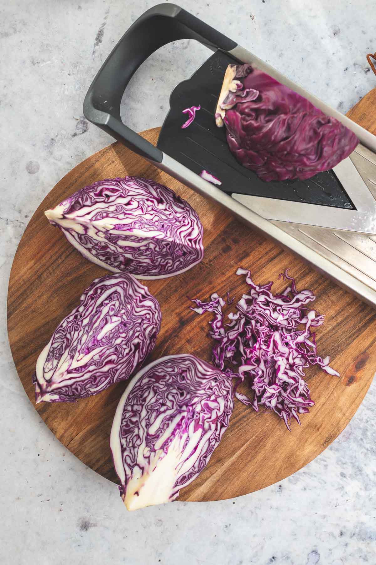 Shredding red cabbage with a mandolin