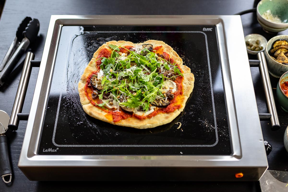 Grilled Pizza mit Aubergine, Oliven, Kapern und Rucola