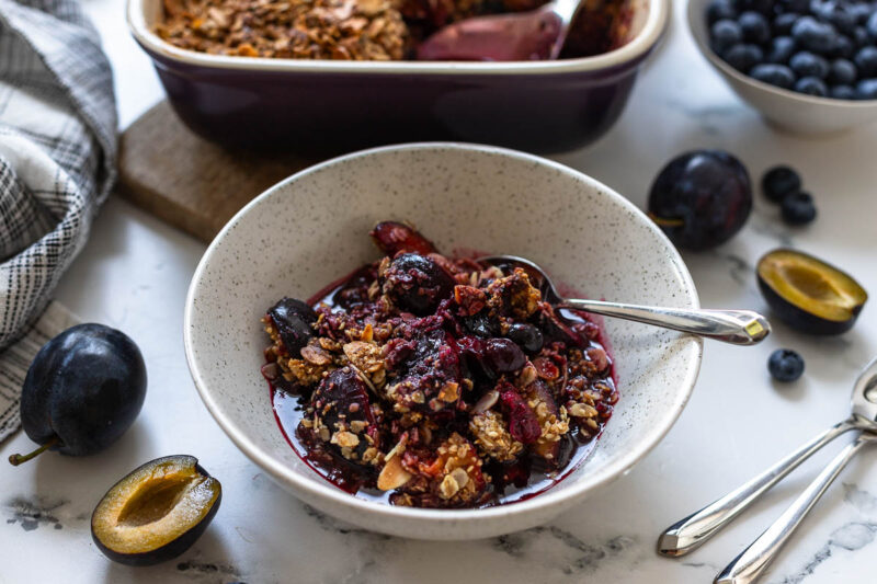 Plum Berry Crisp Recipe with Blueberries and Oat Almond Topping served in bowl