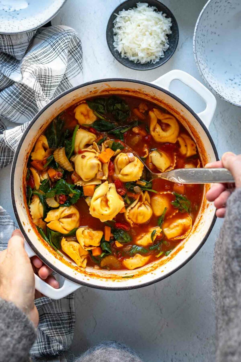 Tortellini Suppe Rezept mit Tomaten und Gemüse im Topf zu servieren