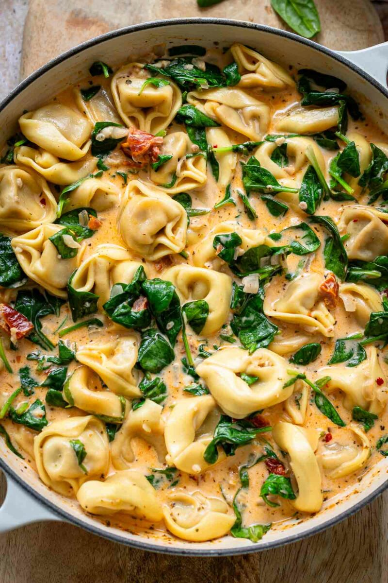 Close Up of tortellini pasta with cream, spinach and sun-dried tomatoes