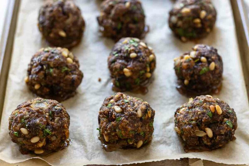 Italian Meatballs (Oven-Baked) made with pine nuts, parmesan, parsley and golden raisins. 