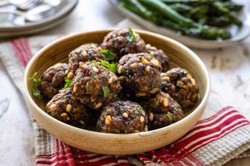 Italian Meatballs (Oven-Baked) made with pine nuts, parmesan, parsley and golden raisins. 