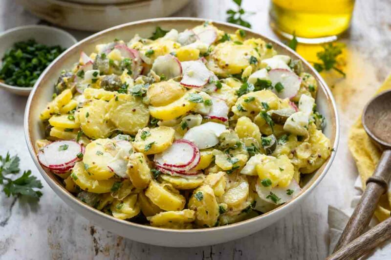 Classic Potato Salad made with creamy mayonnaise, crunchy dill pickles, fresh herbs, and hard-boiled eggs.