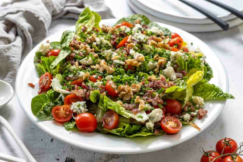 Romaine Salad with crunchy lettuce, crispy bacon, juicy cherry tomatoes, and a creamy, tangy blue cheese vinaigrette