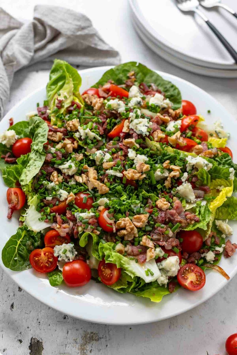 Romaine Salad with crunchy lettuce, crispy bacon, juicy cherry tomatoes, and a creamy, tangy blue cheese vinaigrette