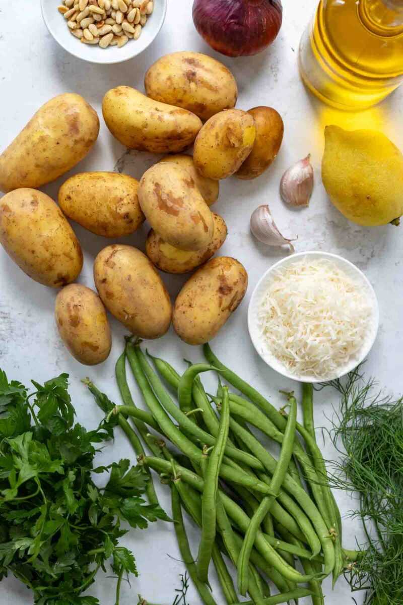 Recipe ingredients: potatoes, green beans, herbs, lemon, parmesan, olive oil, pine nuts