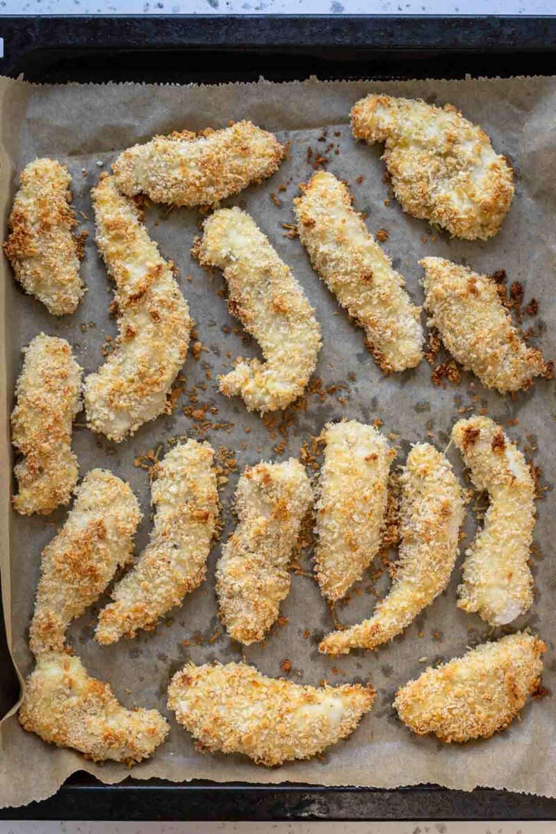 Crispy overn baked Chicken Breast Strips on a baking sheet
