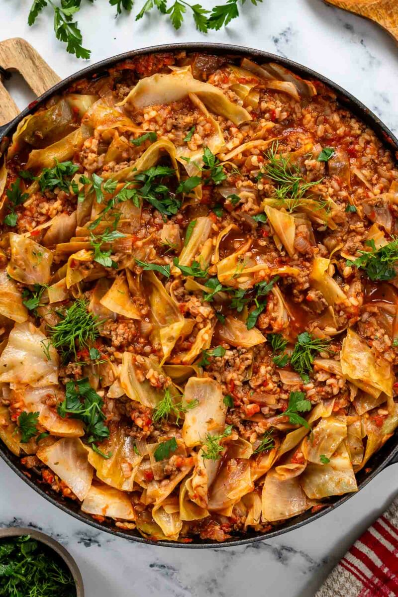 Unstuffed Cabbage Roll Recipe garnished with herbs in the skillet
